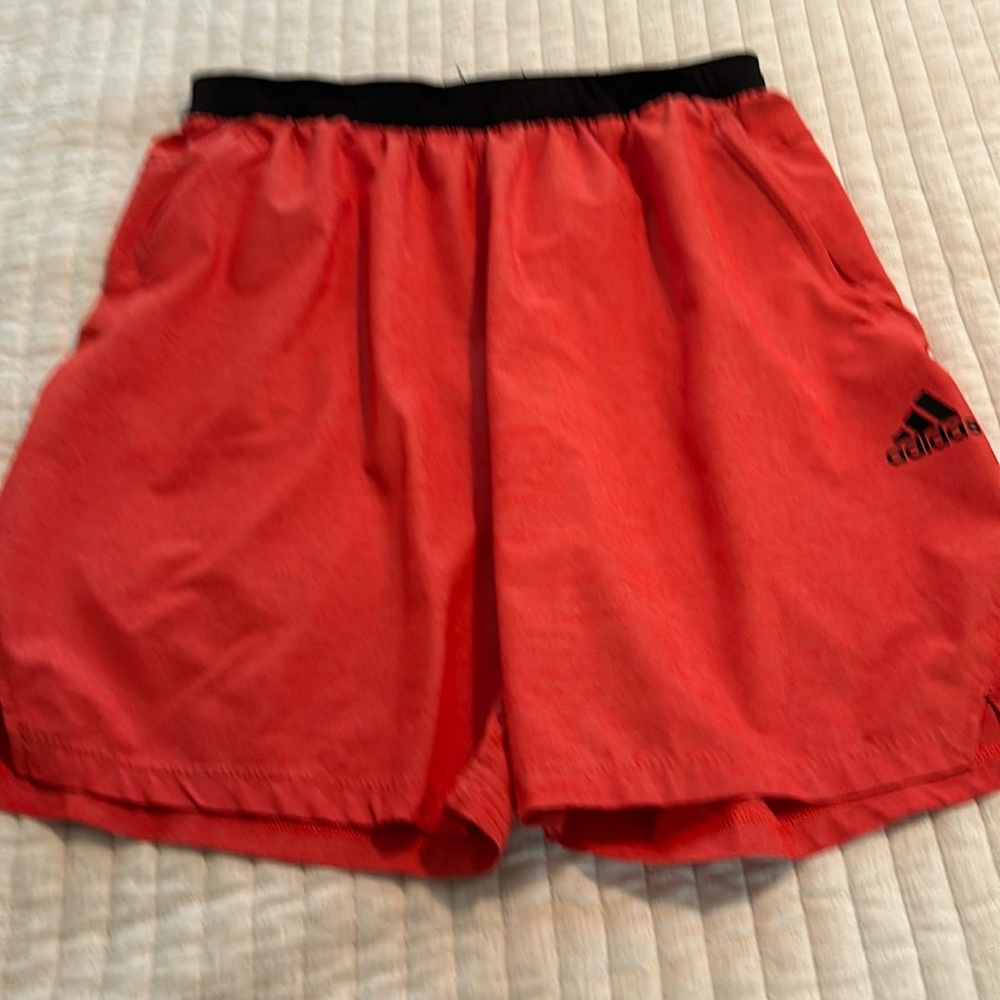 Adidas Mens Dry Fit shorts size XL in Red with zippered pockets.